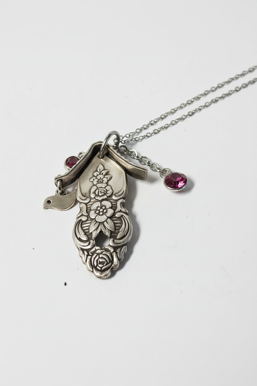 Handcrafted small birdhouse necklace made from reclaimed vintage silverware. Whimsical, cottagecore, eco-friendly jewelry perfect for nature lovers and unique gift giving.