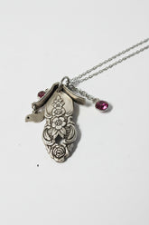 Handcrafted small birdhouse necklace made from reclaimed vintage silverware. Whimsical, cottagecore, eco-friendly jewelry perfect for nature lovers and unique gift giving.