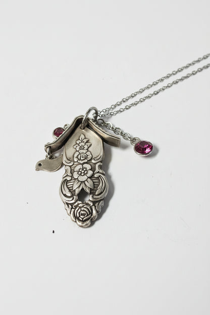 Handcrafted small birdhouse necklace made from reclaimed vintage silverware. Whimsical, cottagecore, eco-friendly jewelry perfect for nature lovers and unique gift giving.