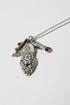 Handcrafted small birdhouse necklace made from reclaimed vintage silverware. Whimsical, cottagecore, eco-friendly jewelry perfect for nature lovers and unique gift giving.