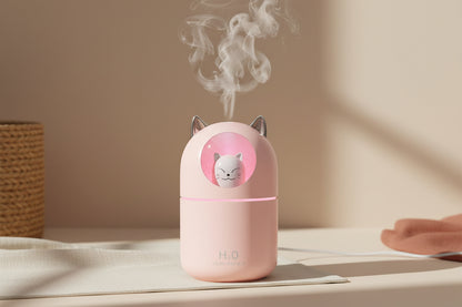 Cute cat mini humidifier with cool mist and soft night light. Quiet 300ml USB humidifier for bedrooms, desks, and nurseries. Auto shut-off.
