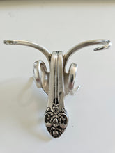 The Lucky Fork Cricket is a handcrafted sculpture made from repurposed vintage silverware, blending artistry with charm. Inspired by crickets—symbols of luck and prosperity—each piece is unique, adorned with jewels and aged patina. A perfect collectible or gift, this whimsical creation brings history, elegance, and positive energy to any space. 