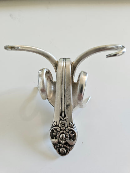 The Lucky Fork Cricket is a handcrafted sculpture made from repurposed vintage silverware, blending artistry with charm. Inspired by crickets—symbols of luck and prosperity—each piece is unique, adorned with jewels and aged patina. A perfect collectible or gift, this whimsical creation brings history, elegance, and positive energy to any space. 