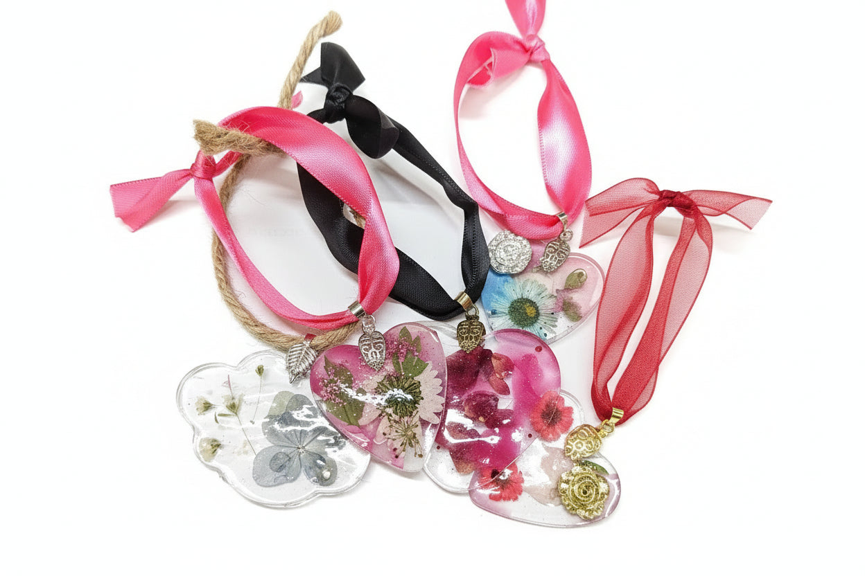 Pressed flower resin suncatcher ornaments with real botanicals in heart, butterfly, and organic shapes—handmade, one-of-a-kind nature keepsakes by Angel Singh.