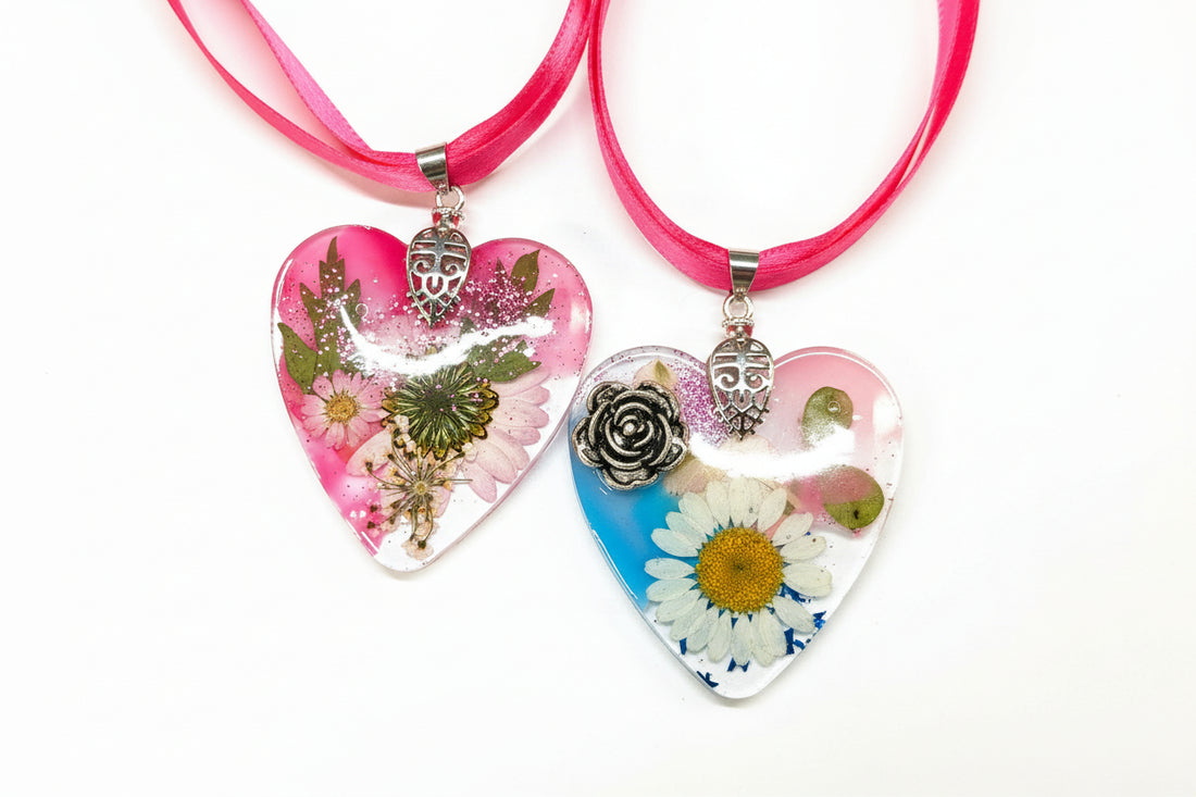 Pressed flower resin suncatcher ornaments with real botanicals in heart, butterfly, and organic shapes—handmade, one-of-a-kind nature keepsakes by Angel Singh.