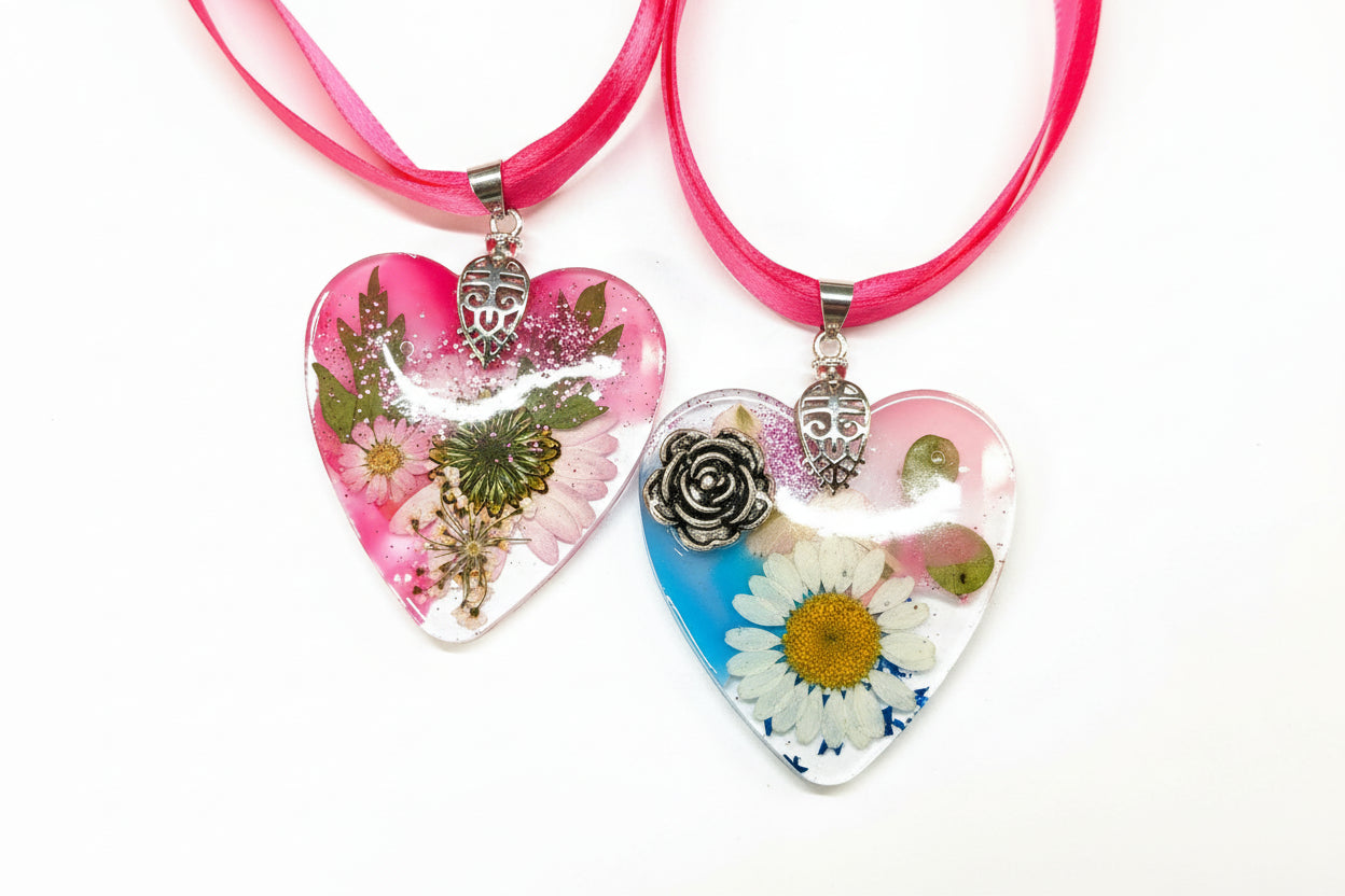 Pressed flower resin suncatcher ornaments with real botanicals in heart, butterfly, and organic shapes—handmade, one-of-a-kind nature keepsakes by Angel Singh.