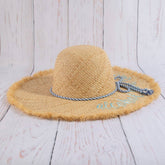Woven raffia sun hat featuring lightweight breathable texture and timeless summer style. Perfect for beach days, vacations, casual outfits, and warm-weather fashion.