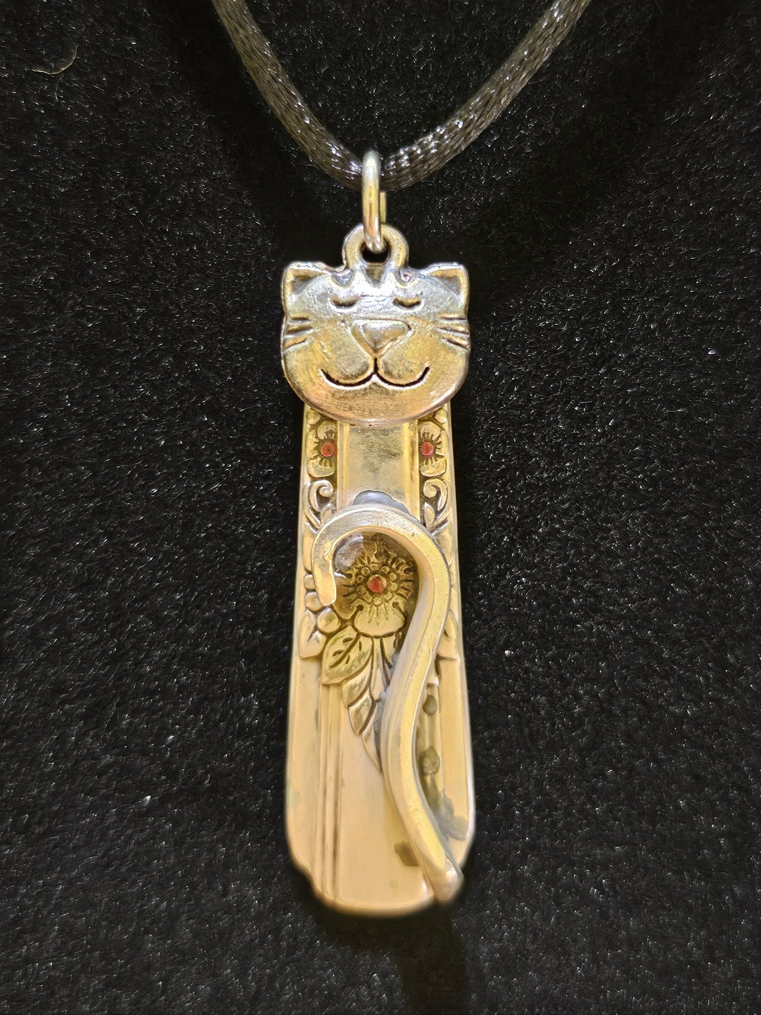 Handmade silver cat pendant necklaces from vintage silverware. Elegant, whimsical, and adjustable on a satin cord. Sustainably crafted and one-of-a-kind.