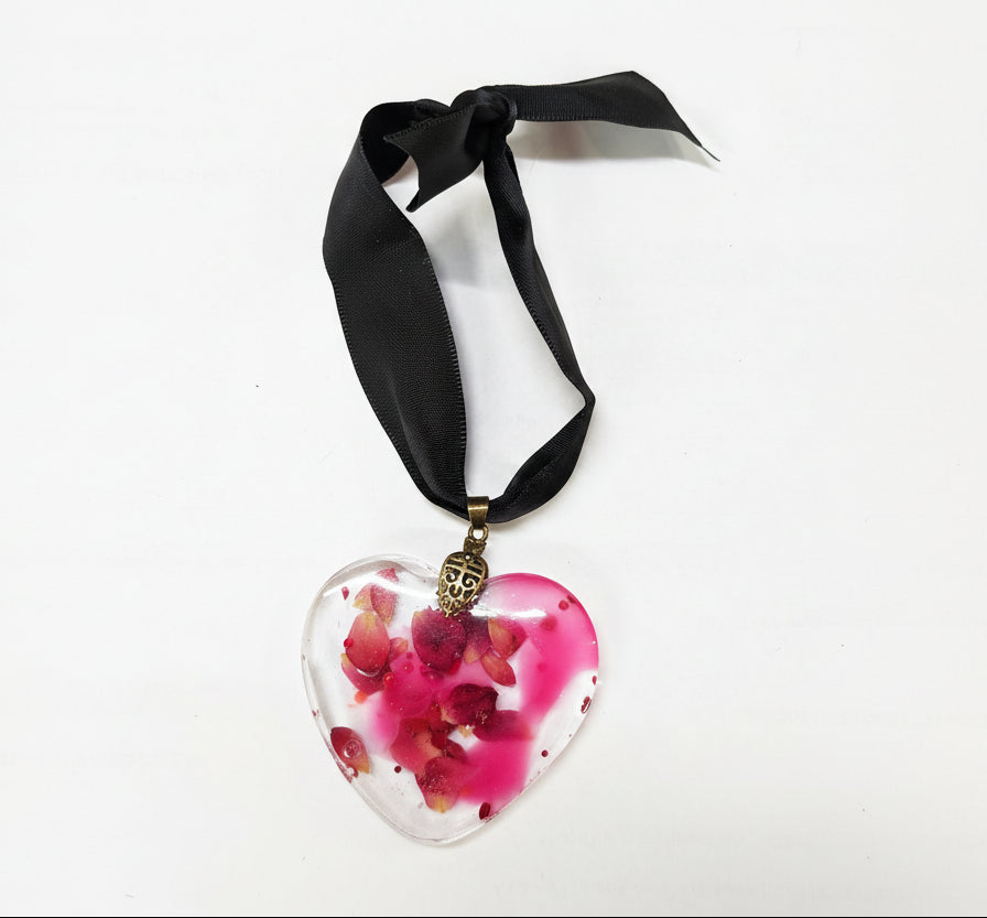 Pressed flower resin suncatcher ornaments with real botanicals in heart, butterfly, and organic shapes—handmade, one-of-a-kind nature keepsakes by Angel Singh.