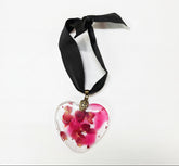 Pressed flower resin suncatcher ornaments with real botanicals in heart, butterfly, and organic shapes—handmade, one-of-a-kind nature keepsakes by Angel Singh.