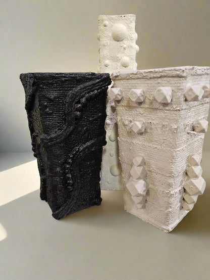 Elevate your space with this handcrafted upcycled glass Relics Cylinder Vase. Made from reclaimed materials, each piece is unique, eco-friendly, and artfully designed. Choose from Matte White, Glossy Black, or Sand finishes. Watertight and perfect for fresh or dried blooms. 