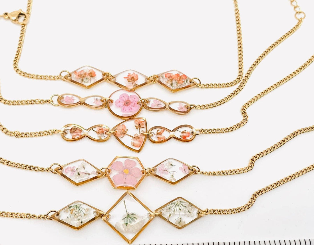 Gold-plated bracelet with real dried flowers in a geometric resin charm. Lightweight, adjustable, and perfect for nature-inspired, elegant everyday wear.