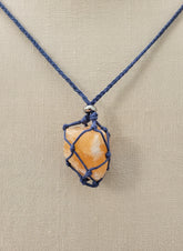 A versatile Crystal and Rock Cage Necklace with an adjustable metal pendant. Swap in your favorite gemstones or charms for a personalized, mystical accessory.