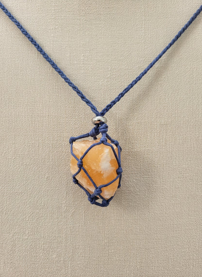 A versatile Crystal and Rock Cage Necklace with an adjustable metal pendant. Swap in your favorite gemstones or charms for a personalized, mystical accessory.