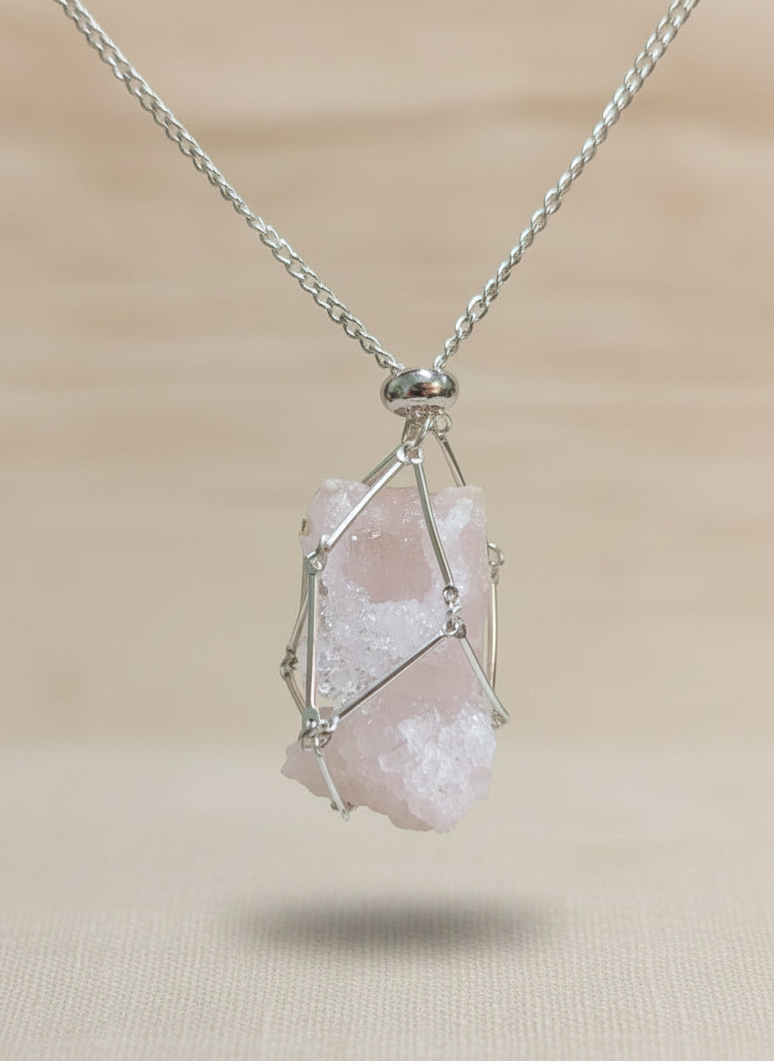 A versatile Crystal and Rock Cage Necklace with an adjustable metal pendant. Swap in your favorite gemstones or charms for a personalized, mystical accessory.