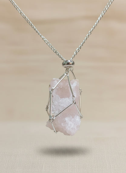 A versatile Crystal and Rock Cage Necklace with an adjustable metal pendant. Swap in your favorite gemstones or charms for a personalized, mystical accessory.