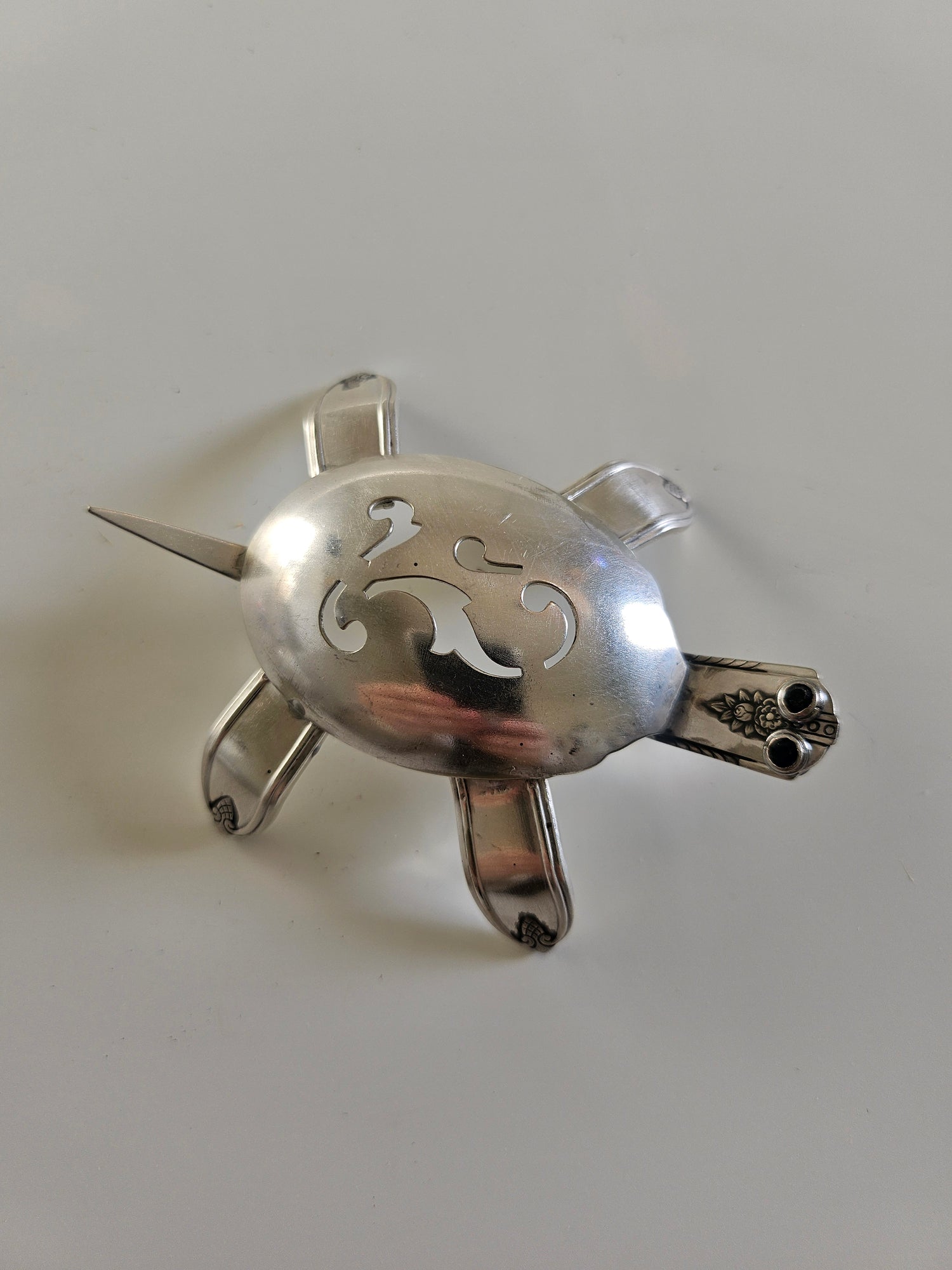 Handcrafted from vintage silverware, these salvaged scorpion and turtle sculptures bring charm, symbolism, and eco-friendly artistry to any space