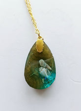 Sea Life Resin Pendant Necklaces by artist KStonely featuring shells, fish, jellyfish, and sea life miniatures in dreamy blue, brown, and gold ocean-inspired resin.