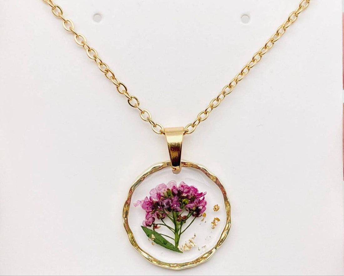 Real pressed flower round pendant necklace in clear resin. Lightweight, nature-inspired, and handcrafted for a unique botanical jewelry statement.