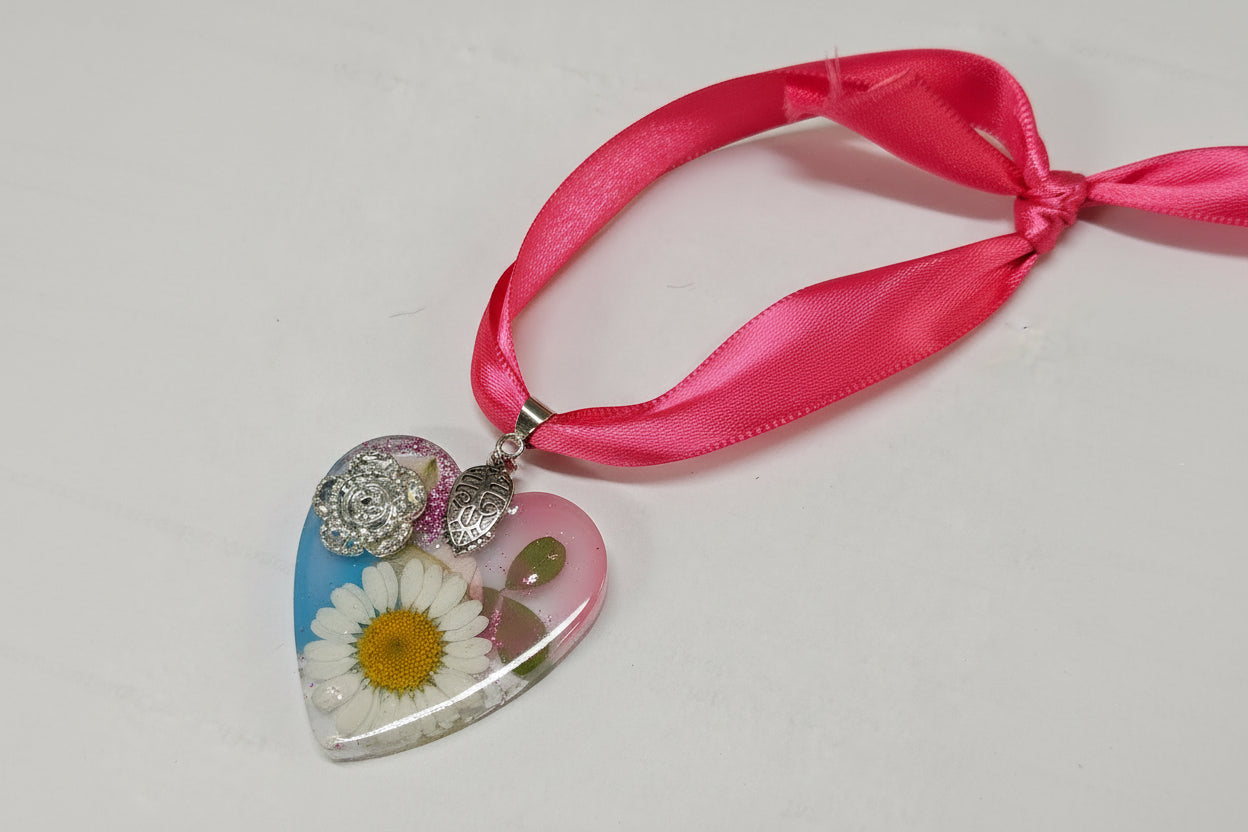 Pressed flower resin suncatcher ornaments with real botanicals in heart, butterfly, and organic shapes—handmade, one-of-a-kind nature keepsakes by Angel Singh.