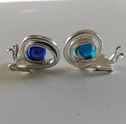 Handcrafted from vintage silverware, these whimsical snails feature shimmering glass orb shells—each a one-of-a-kind symbol of patience and charm.