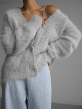 Luxuriously soft fluffy V-neck button-down cardigan with relaxed fit and cozy texture. Wear on or off shoulder—perfect for chic fall and winter layering.