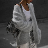 Luxuriously soft fluffy V-neck button-down cardigan with relaxed fit and cozy texture. Wear on or off shoulder—perfect for chic fall and winter layering.
