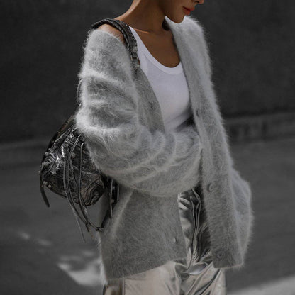Luxuriously soft fluffy V-neck button-down cardigan with relaxed fit and cozy texture. Wear on or off shoulder—perfect for chic fall and winter layering.