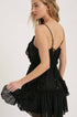 Swiss dot mini dress with ruffle details, lace-up back, adjustable straps & waist tie. Lightweight rayon, perfect for warm days & effortlessly chic looks.