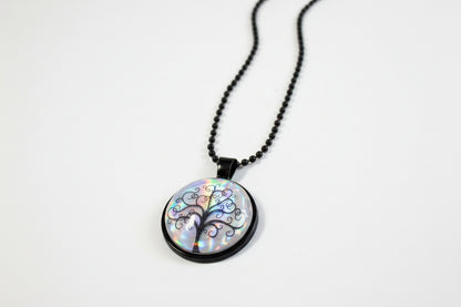 Handcrafted nature scene necklaces with real botanicals in iridescent and clear resin. Unique, wearable landscapes on chain or satin cord.