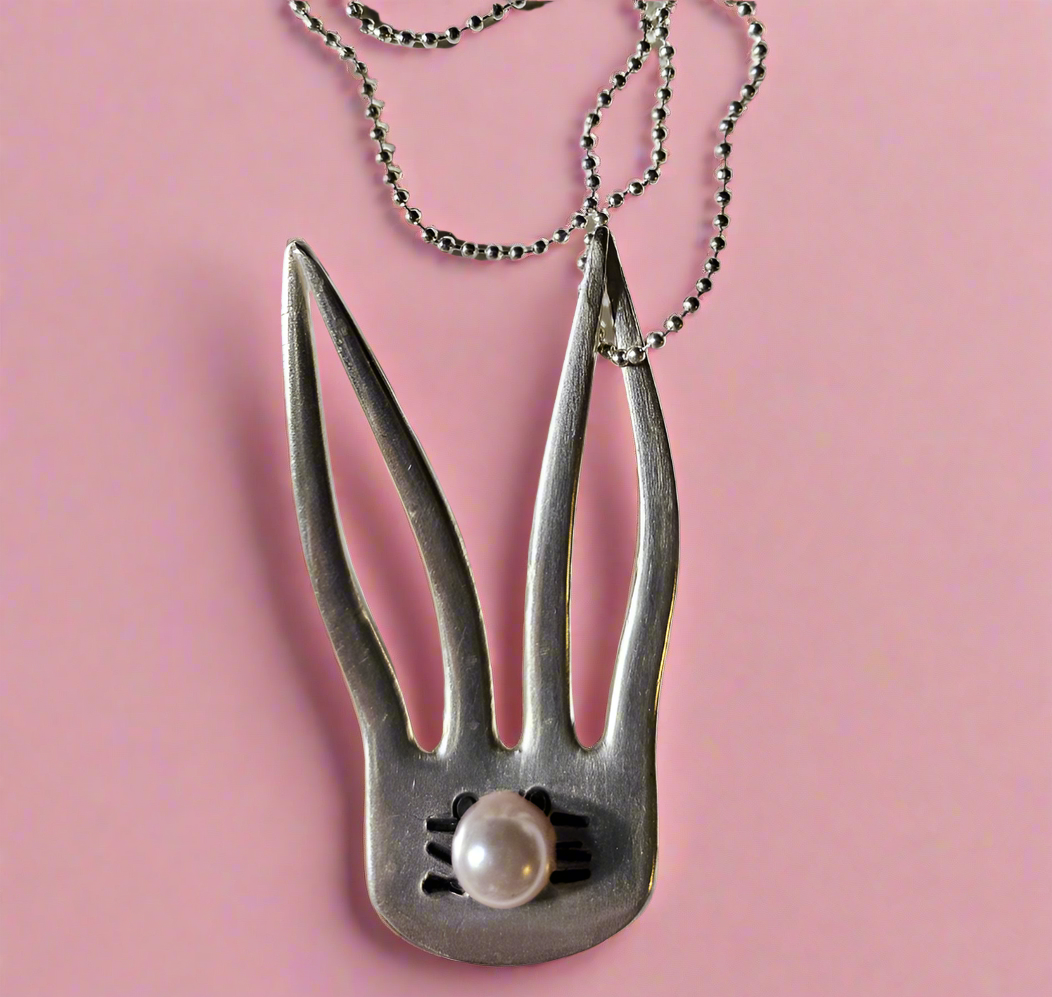 The Salvaged Silver Bunny Pendant is a handcrafted, one-of-a-kind piece made from recycled vintage silverware. Designed by artisan KStonely, it blends whimsical Easter charm with sustainable craftsmanship. Lightweight and unique, it’s perfect for everyday wear or special occasions. A timeless, upcycled treasure that celebrates history and artistry. 
