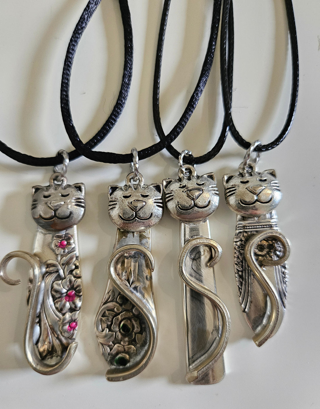 Handmade silver cat pendant necklaces from vintage silverware. Elegant, whimsical, and adjustable on a satin cord. Sustainably crafted and one-of-a-kind.