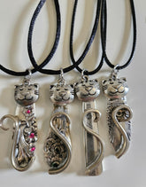 Handmade silver cat pendant necklaces from vintage silverware. Elegant, whimsical, and adjustable on a satin cord. Sustainably crafted and one-of-a-kind.