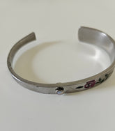 Handcrafted 6" floral cuff bracelet made from vintage silverware with a jewel accent. A one-of-a-kind piece blending antique charm and timeless elegance.