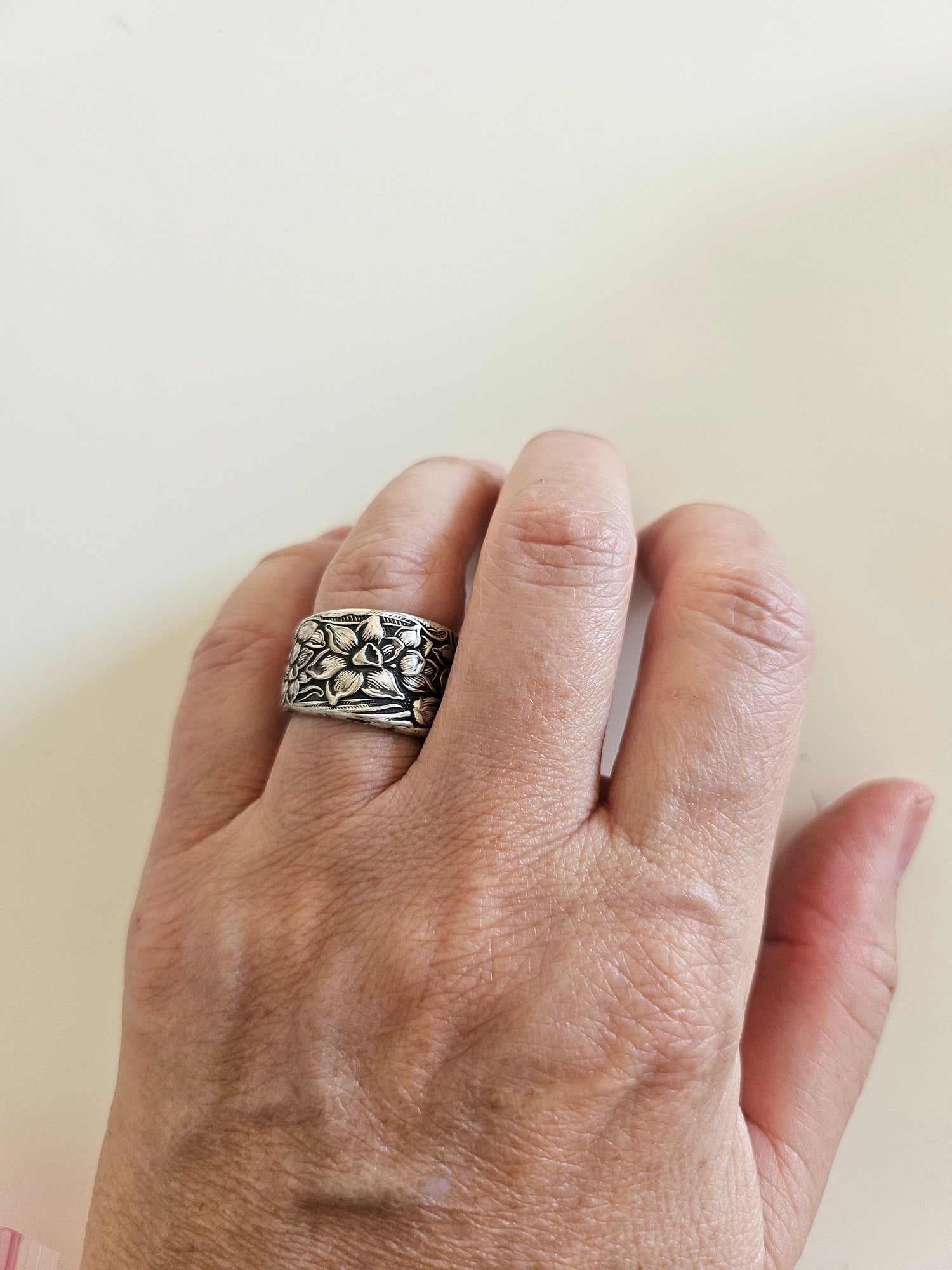 Handcrafted from 1935 Narcissus silverware, this adjustable floral ring by National Silver Co. brings vintage elegance and timeless charm to any outfit.