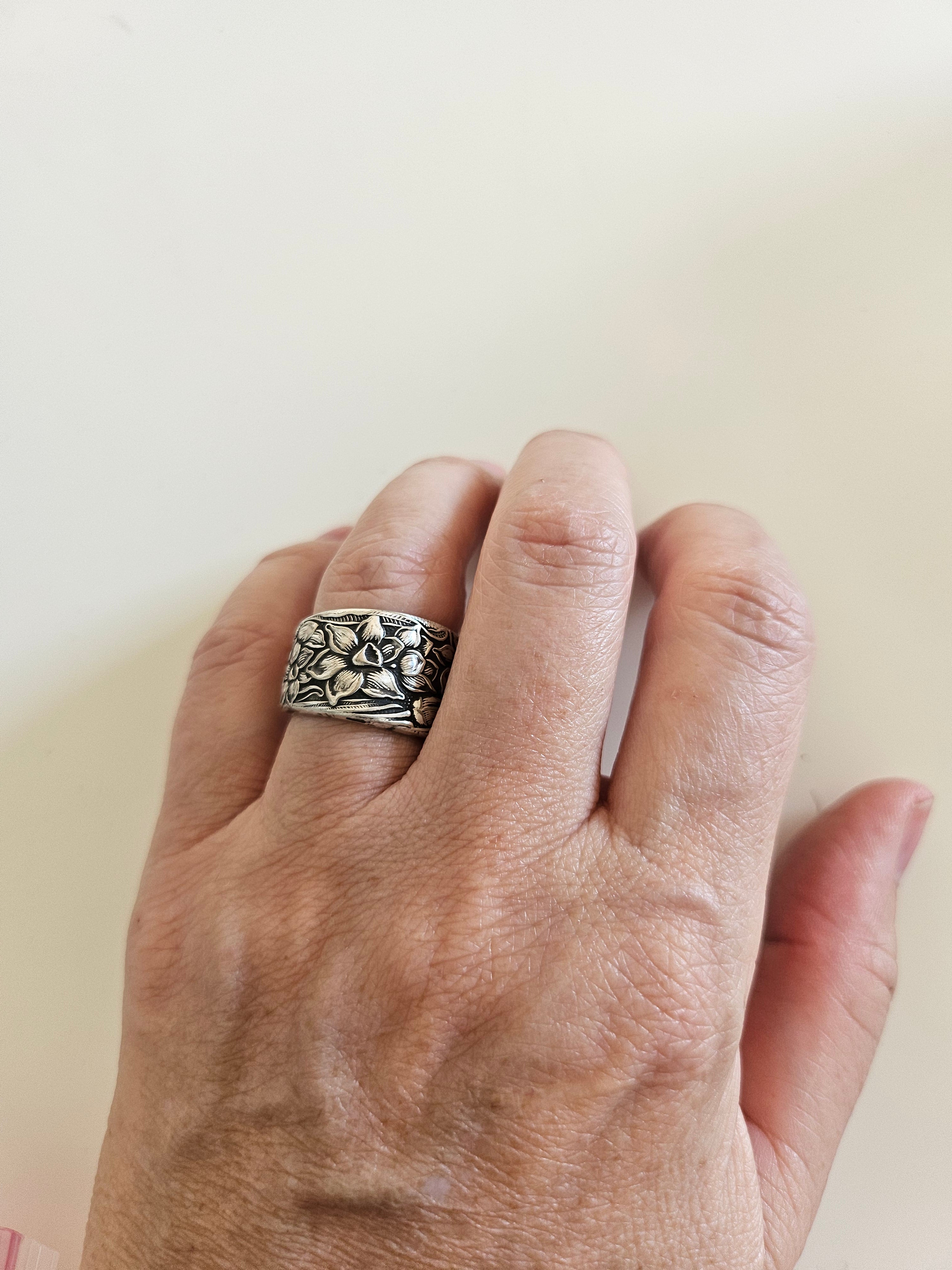 Handcrafted from 1935 Narcissus silverware, this adjustable floral ring by National Silver Co. brings vintage elegance and timeless charm to any outfit.