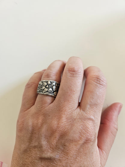 Handcrafted from 1935 Narcissus silverware, this adjustable floral ring by National Silver Co. brings vintage elegance and timeless charm to any outfit.