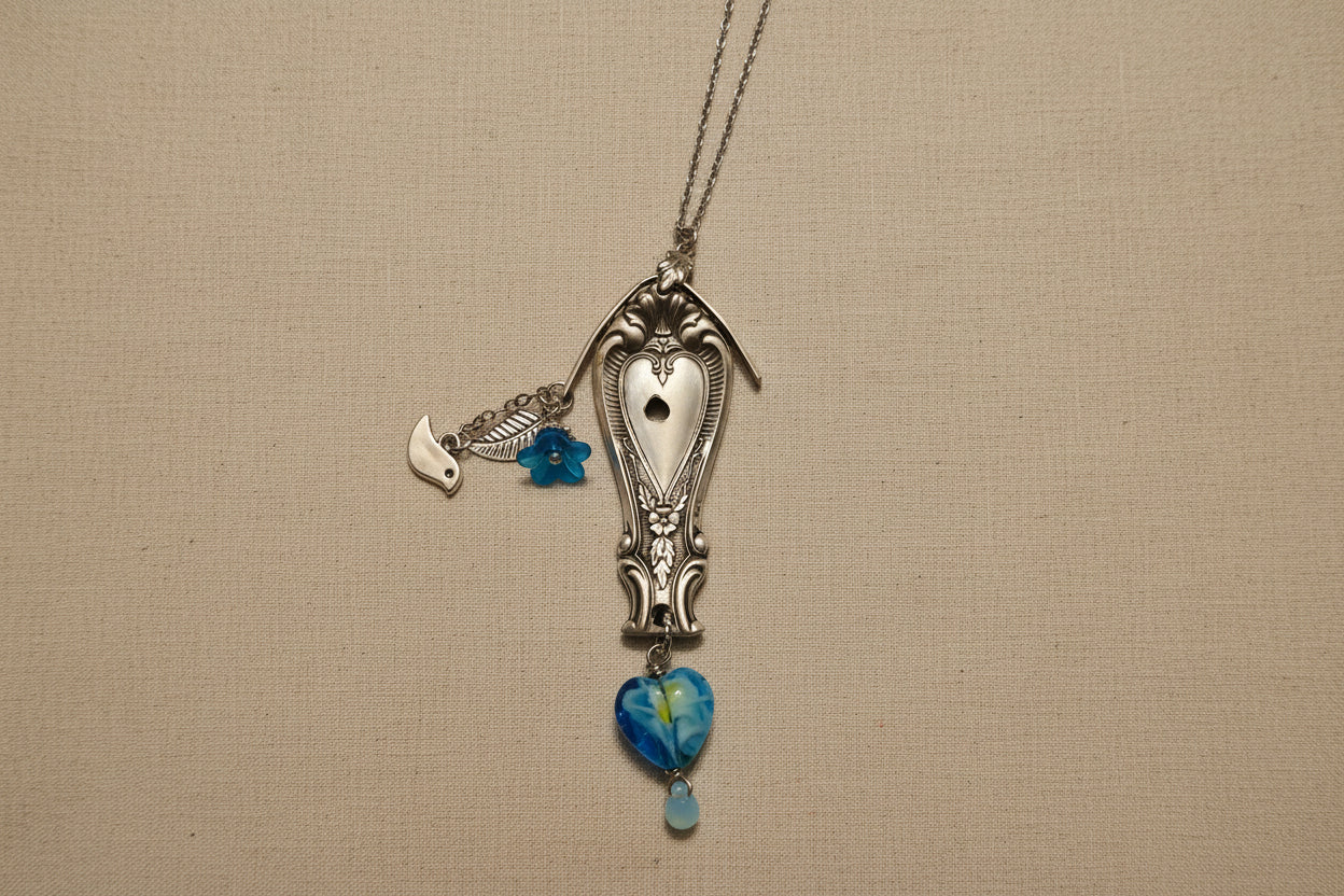 Vintage Sweetheart collectible silverware pattern transformed into a handcrafted birdhouse necklace. Sustainable cottagecore heirloom jewelry.