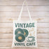 Vintage Vinyl Café Tote Bag featuring retro record shop artwork and a relaxed oversized design. Lightweight, stylish, and perfect for everyday essentials.