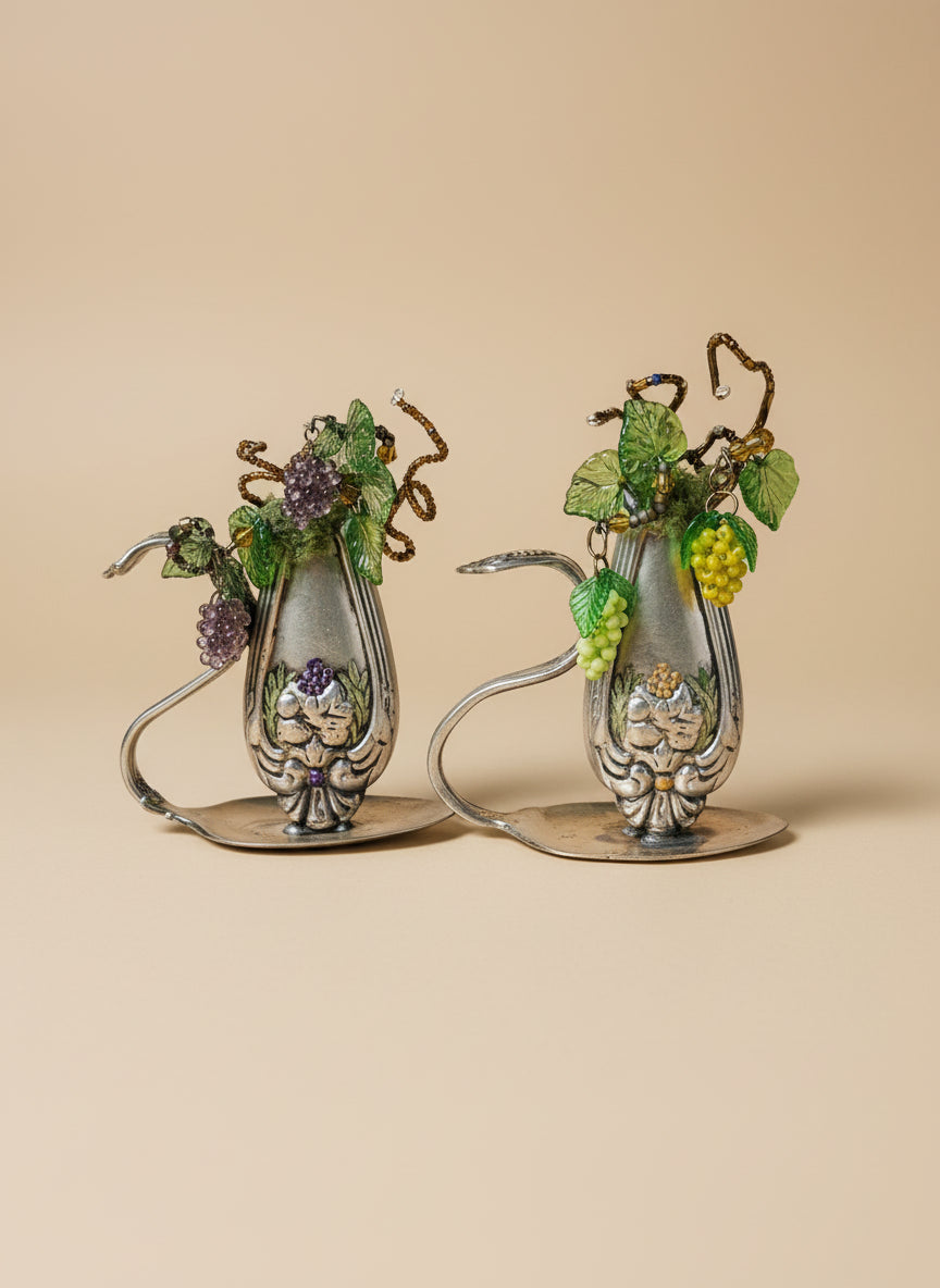 Vintage silverware bud vase with handcrafted beaded flowers by artist KStonely. Unique, eco-friendly cottagecore décor perfect for shelves, desks, and gifting.