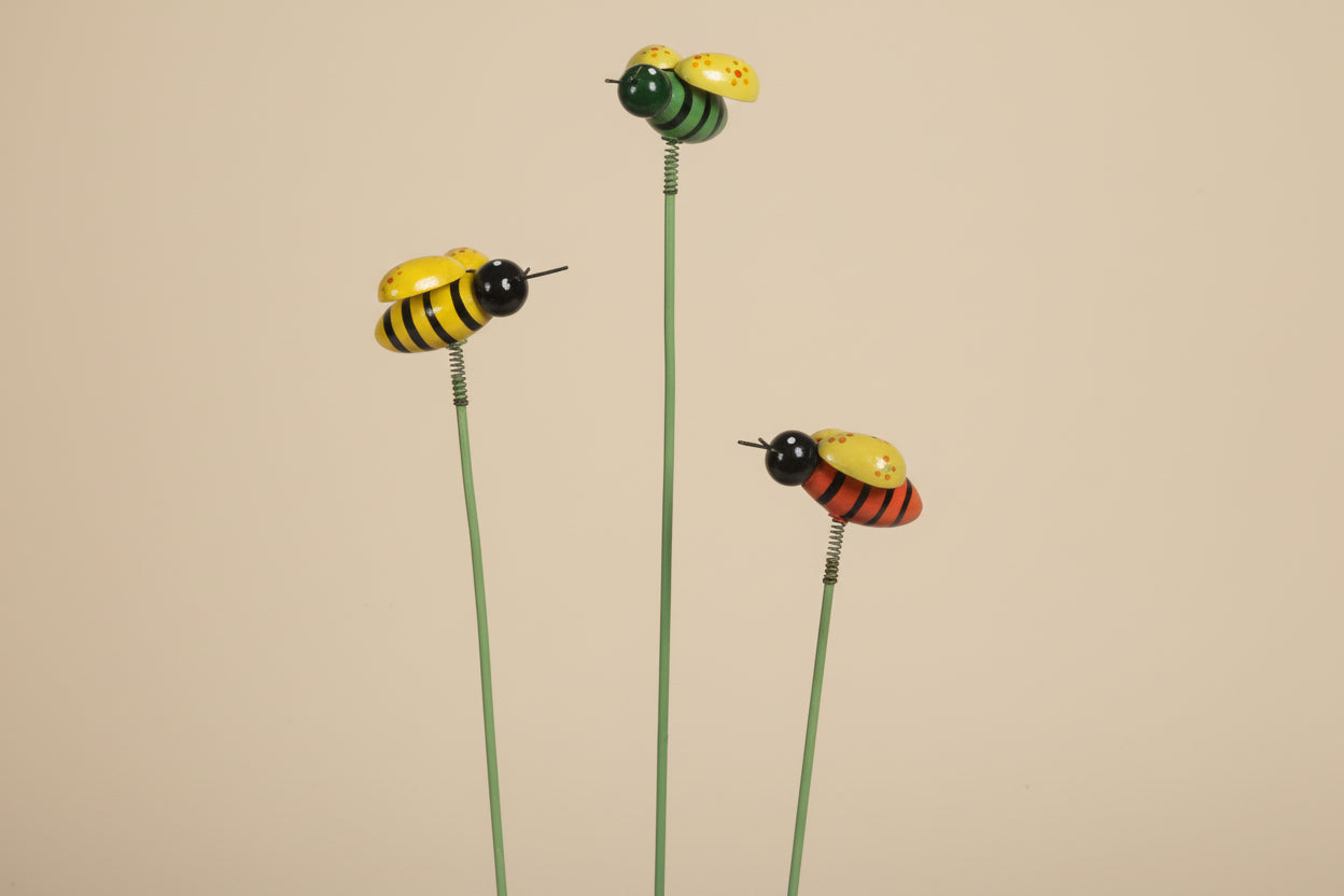 Whimsical bee plant picks with wooden bees on springs. Adds playful movement to houseplants and gardens. Adjustable 19" stake. No plants included.