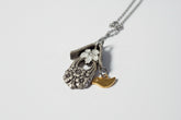 Handcrafted small birdhouse necklace made from reclaimed vintage silverware. Whimsical, cottagecore, eco-friendly jewelry perfect for nature lovers and unique gift giving.