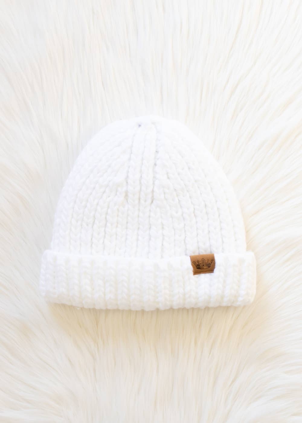 White chunky knit cuffed beanie with cozy fleece lining. Made from 100% acrylic, this classic winter hat adds warmth and timeless style to chilly days.