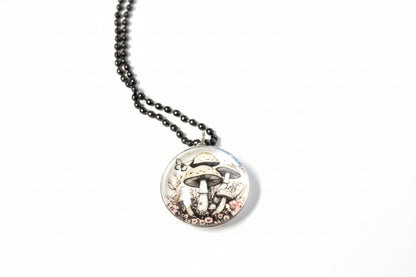 Handcrafted nature scene necklaces with real botanicals in iridescent and clear resin. Unique, wearable landscapes on chain or satin cord.