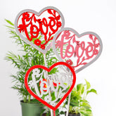 Wooden heart plant picks with built-in clip for cards or notes. Perfect finishing touch for houseplant gifts. Trim-to-fit 18" stake. No plants included.