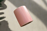 Mini blush ceramic pot (2.25" tall) perfect for air plants or tiny succulents. Smooth glazed finish adds a modern touch. Plant not included. Indoor use.