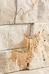 Shimmering beaded tassel chandelier earrings with a lightweight metal ring, hypoallergenic fish hooks, and dazzling glass beads—perfect for any occasion! 