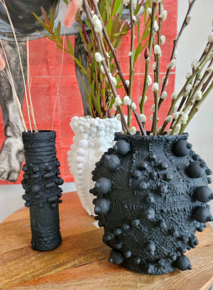 Elevate your decor with this handcrafted upcycled glass urn-shaped vase, made from reclaimed materials for a sustainable touch. Available in Glossy Black or Matte White, each unique piece offers artistic flair and eco-friendly style. Perfect for fresh or dried flowers, it suits both indoor and covered outdoor spaces.